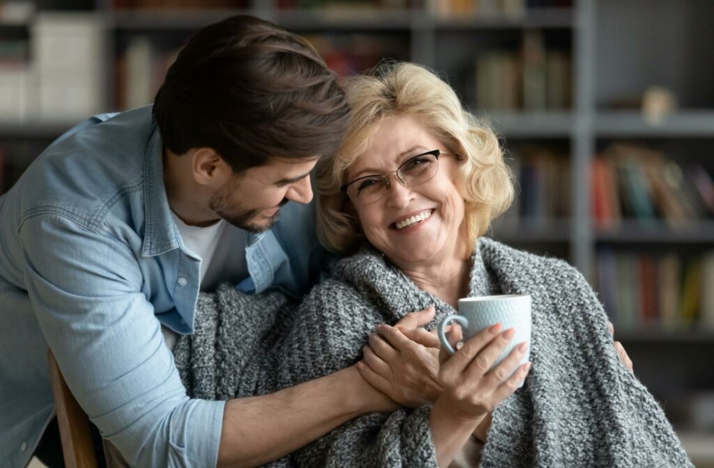 young person hugs senior woman