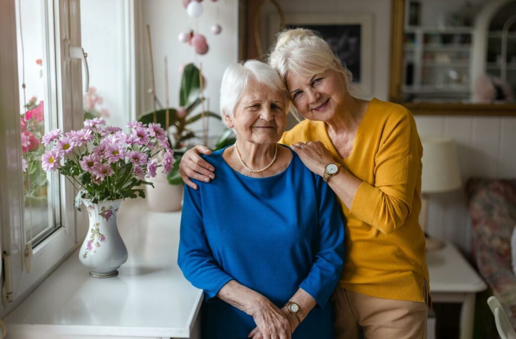 a senior and their older child embracing